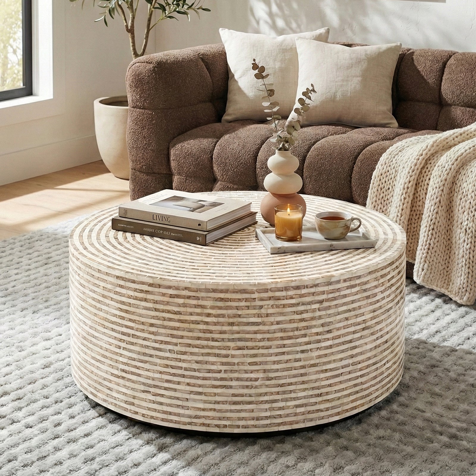 Round mosaic coffee table in a living room with sofa and decor