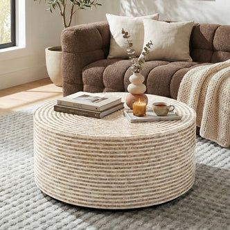 Round mosaic coffee table in a living room with sofa and decor