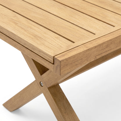 Close-up of wooden table corner with slatted top and crossed leg detail