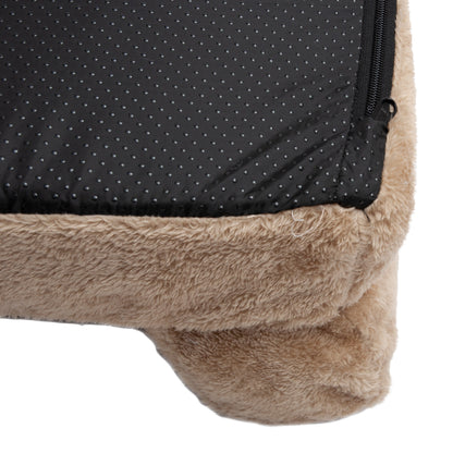 Close-up of tan plush bed corner with black non-slip bottom and zipper