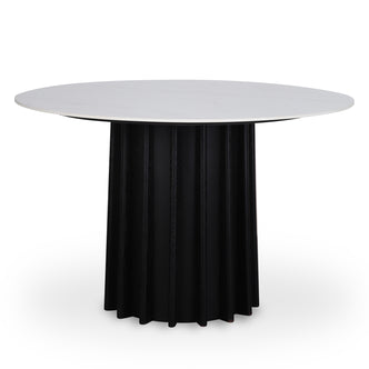 Gabi 120cm Marble Look Dining Table in Black featuring a round, smooth white tabletop atop a tall black cylindrical base with fluted detailing, offering a sophisticated and space-smart dining solution.