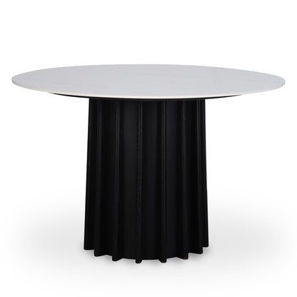 Gabi 120cm Marble Look Dining Table in Black featuring a round, smooth white tabletop atop a tall black cylindrical base with fluted detailing, offering a sophisticated and space-smart dining solution.