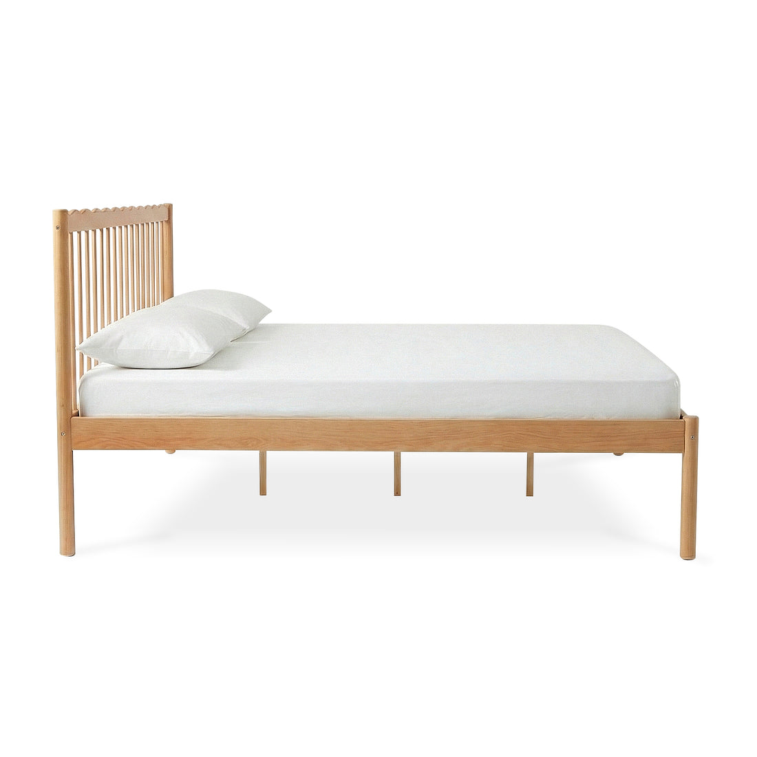 Wooden bed frame with slatted headboard, white mattress and single pillow on white background