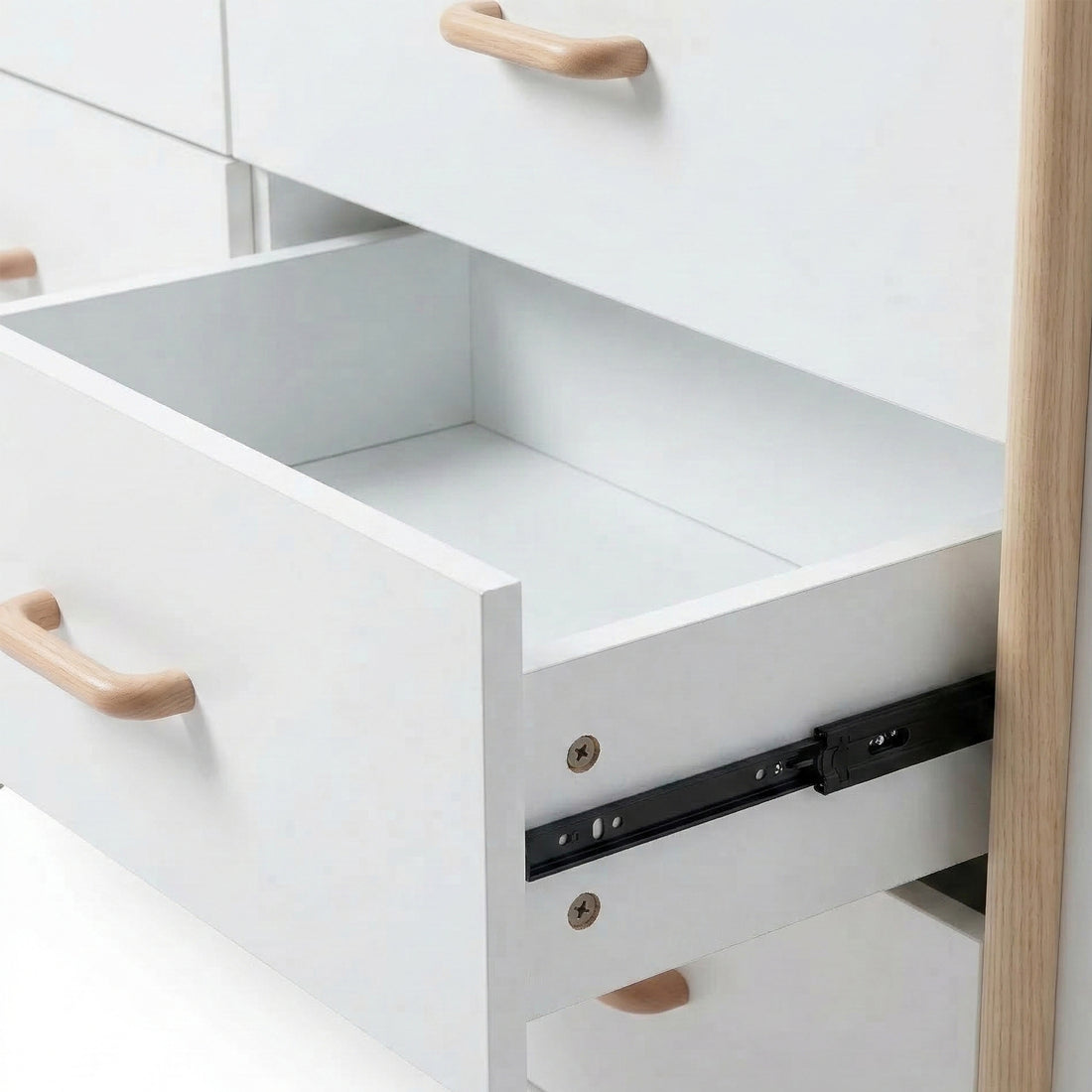 Close-up of open dresser drawer showing interior and slide mechanism on white background