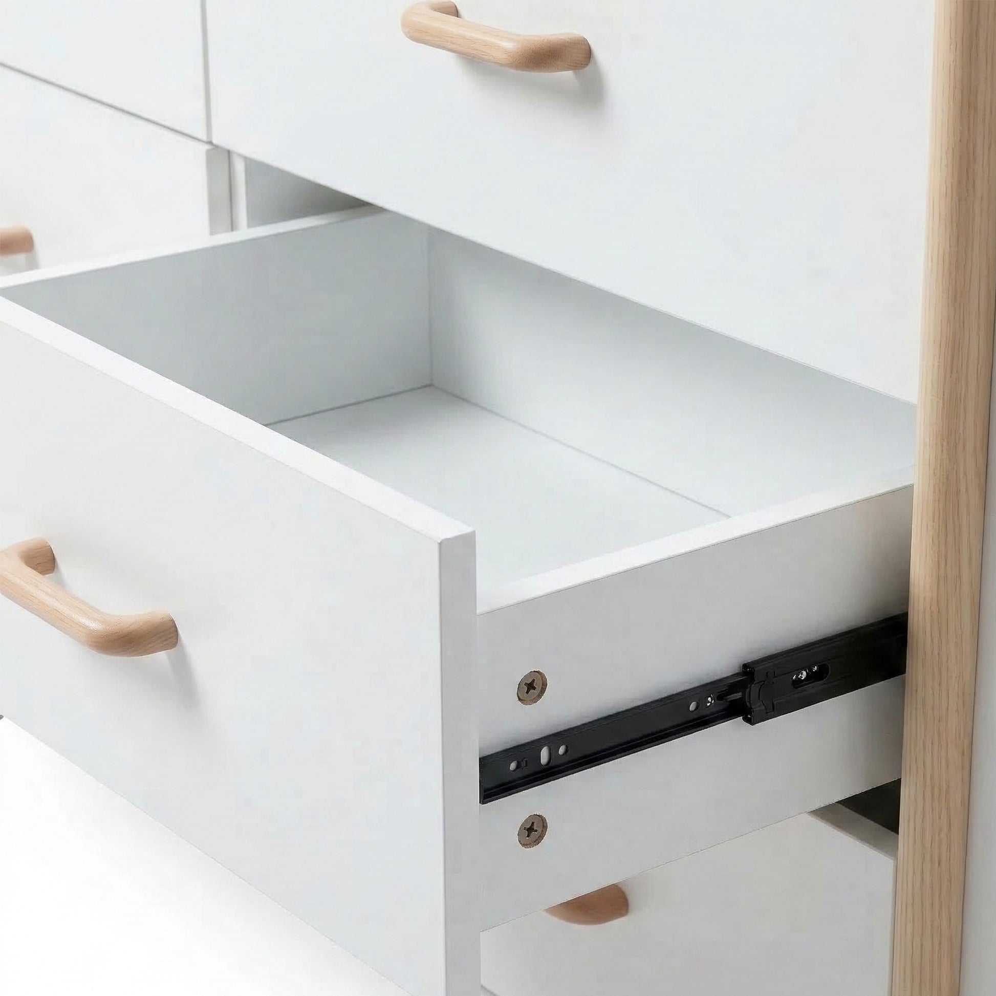 Close-up of open dresser drawer showing interior and slide mechanism on white background