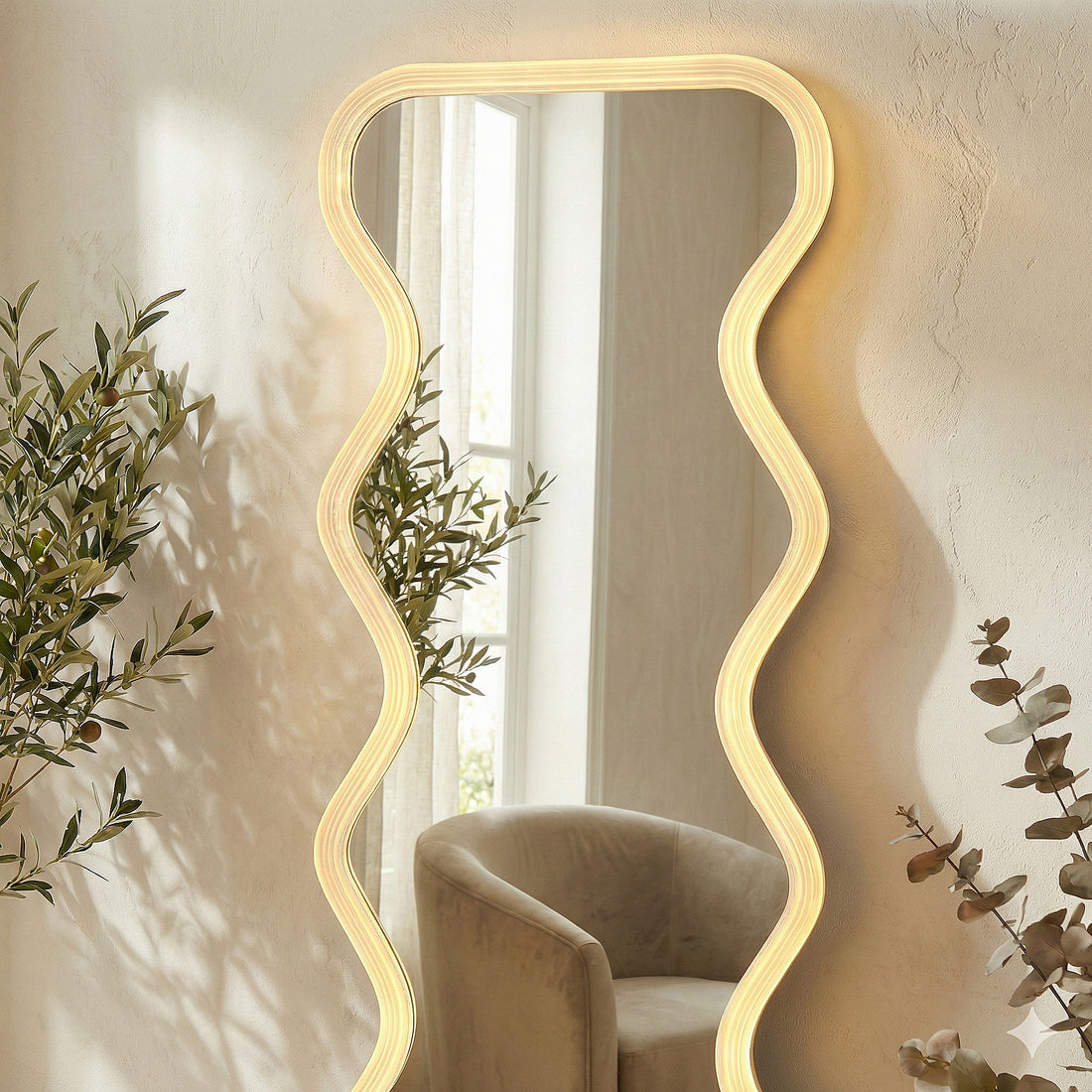 Wavy LED mirror in a bright room with a modern chair and green plants