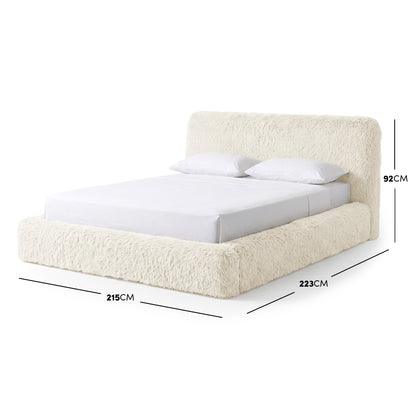 Full upholstered bed on white background with dimension measurements shown