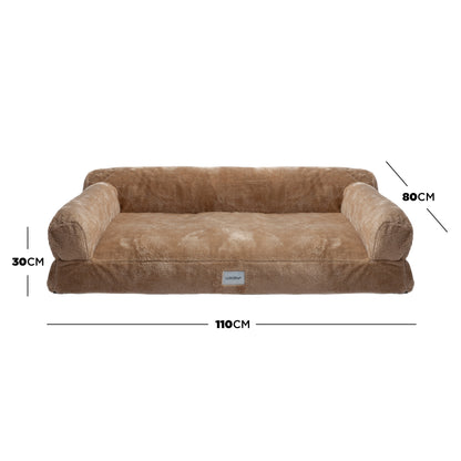 Plush tan dog bed with bolsters and dimensions marked on white background