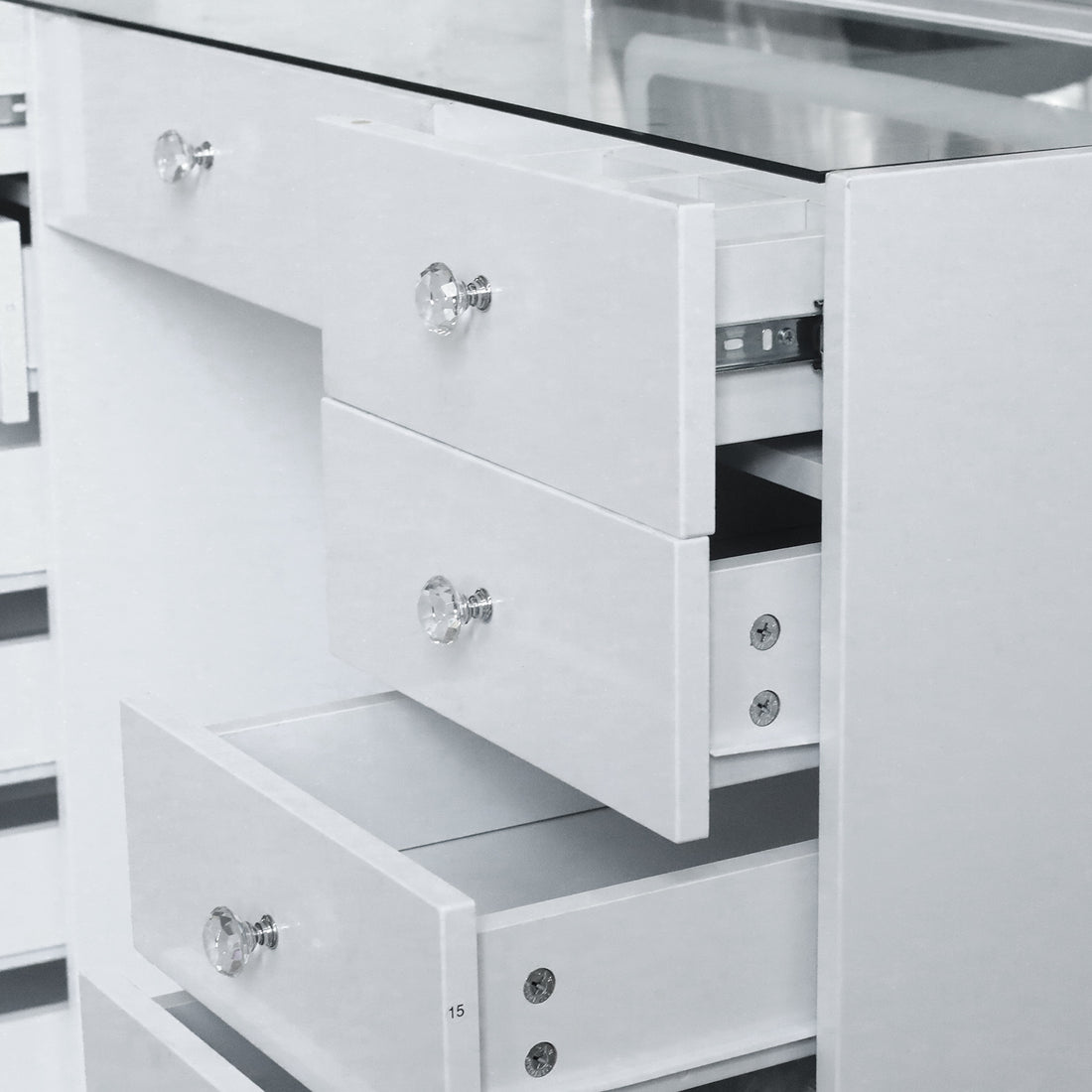 Partial view of white vanity chest of drawers in a room
