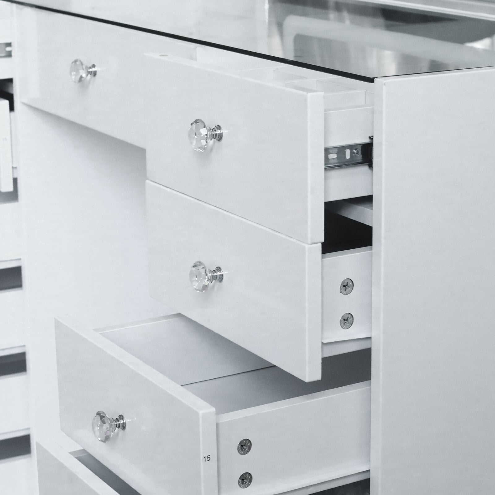 Partial view of white vanity chest of drawers in a room