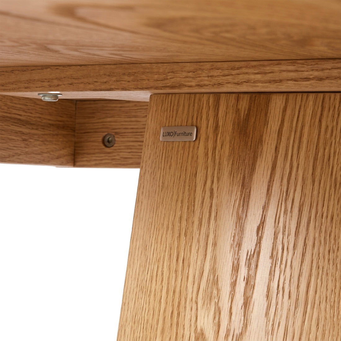 Close-up of wooden furniture corner with wood grain, screws, and brand label