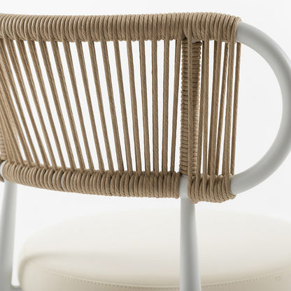 Close-up of the Cabria 9 Piece Sintered Stone Outdoor Dining Set in Beige, highlighting the white metal frame with tan rope on the chair's backrest and a light-beige upholstered cushion.