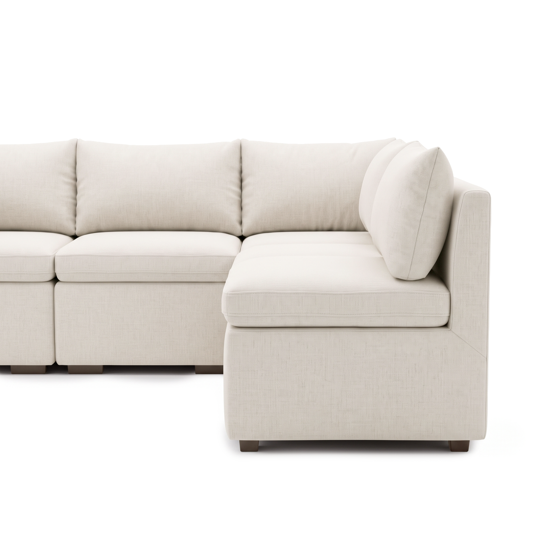 Close view of the right chaise section of a cream modular sofa