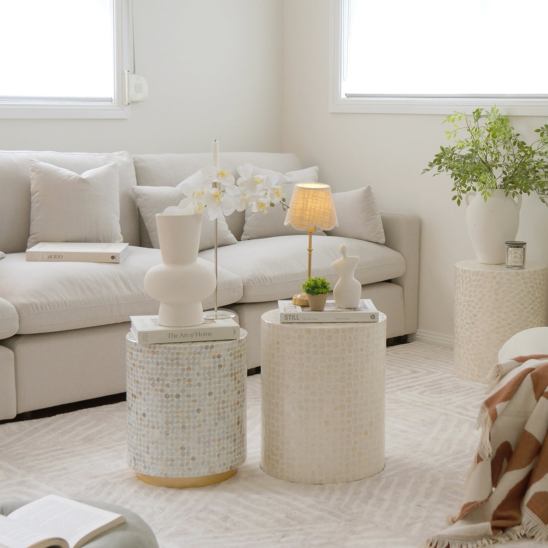 Styled living room with round accent tables and a sectional sofa