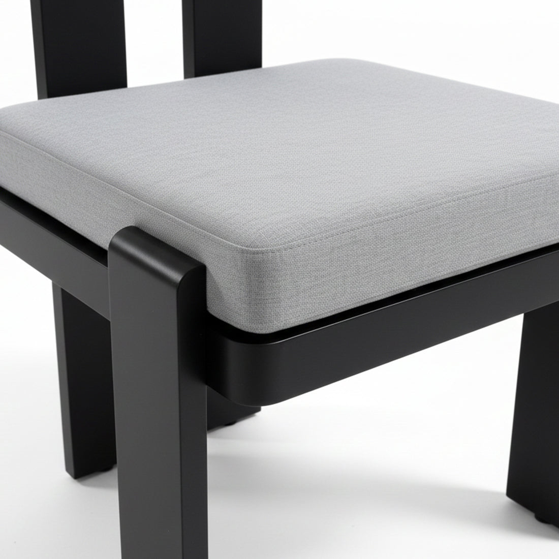 Close-up of a light-gray upholstered seat cushion on a black frame from the Positano 6 Seater Outdoor Dining Set in Black & Grey, showcasing modern design and outdoor-ready comfort.