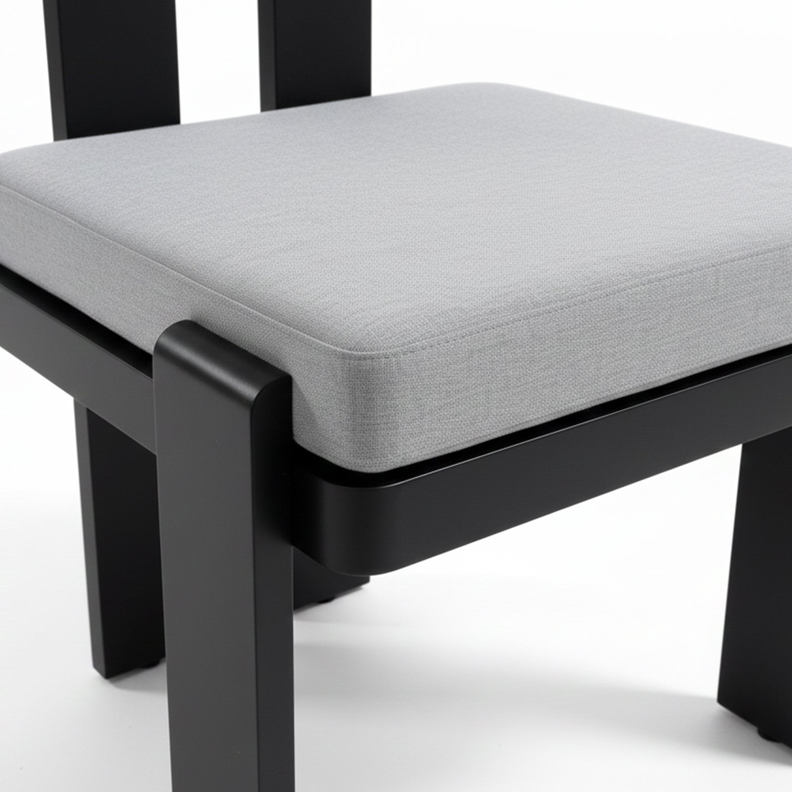 Close-up of a light-gray upholstered seat cushion on a black frame from the Positano 6 Seater Outdoor Dining Set in Black & Grey, showcasing modern design and outdoor-ready comfort.