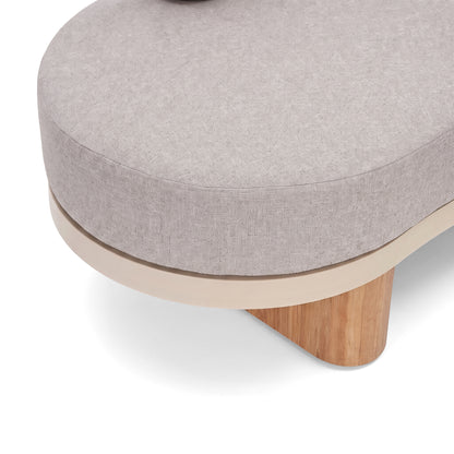 Close-up of a modern upholstered furniture piece with wooden base on a white background.
