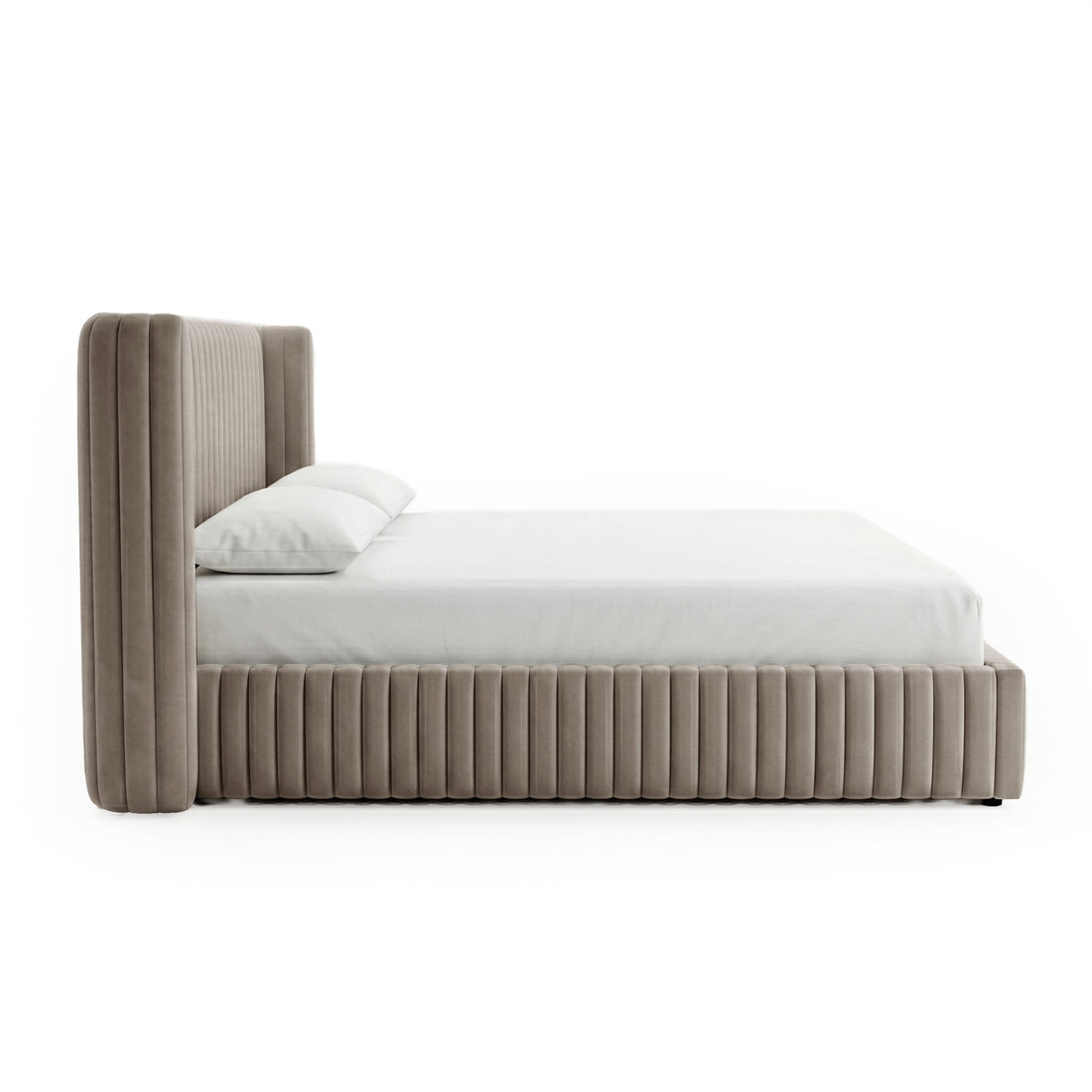 Side profile of a complete taupe upholstered platform bed on white