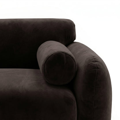 Close-up of rounded armrest and bolster pillow on sectional sofa