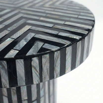 Extreme close-up of geometric inlay pattern on table top against white background