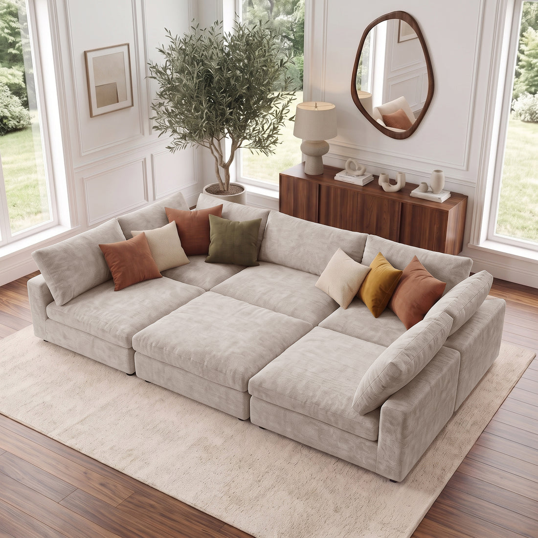Large beige sectional sofa in a bright styled living room with colorful pillows.
