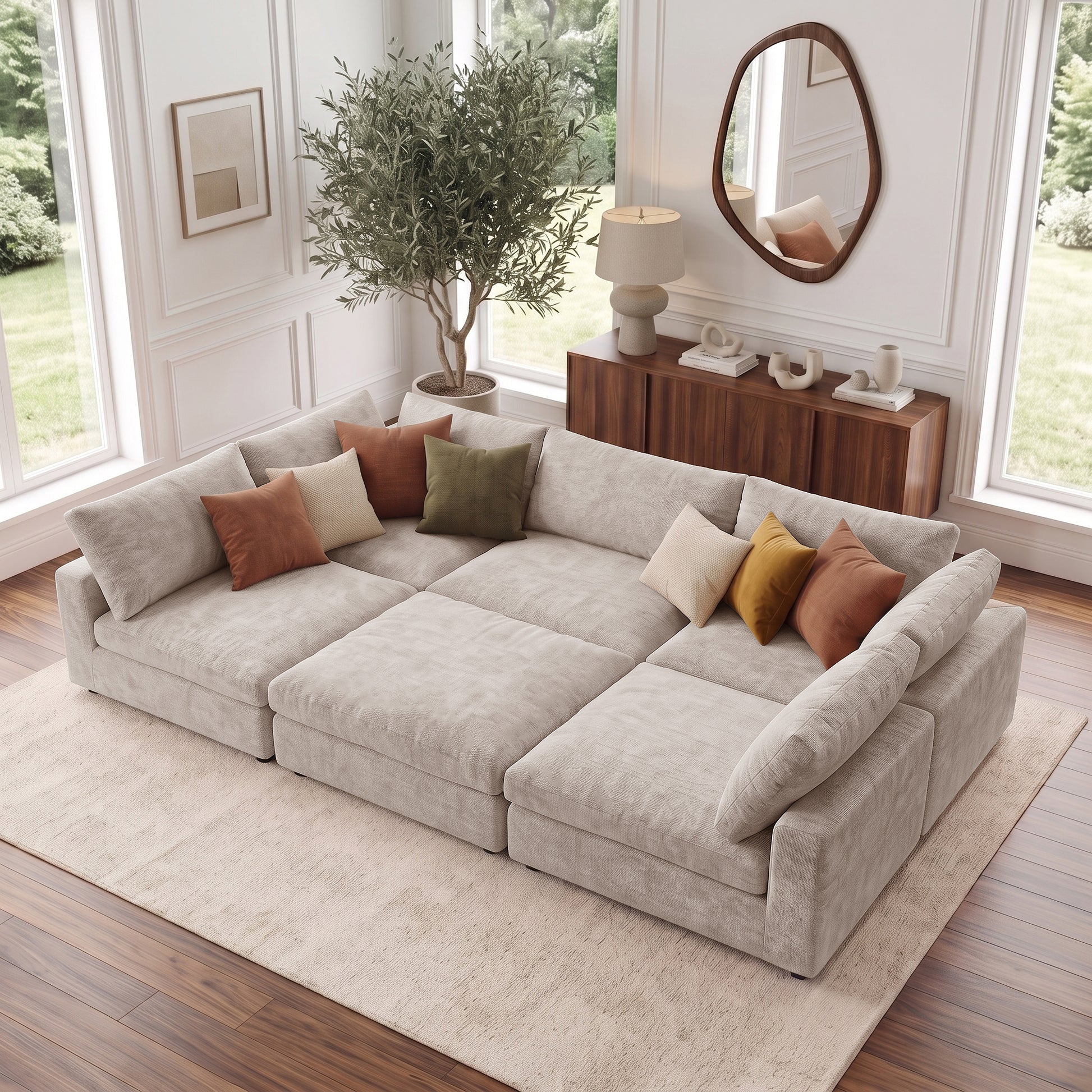 Large beige sectional sofa in a bright styled living room with colorful pillows.