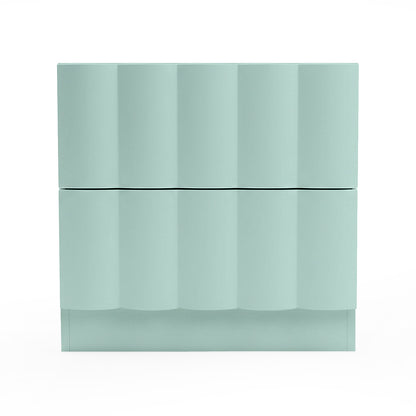 Mint green chest of drawers with wavy geometric front on white background