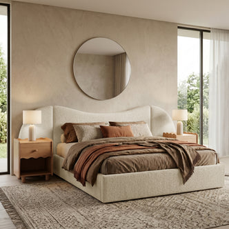 Beige upholstered bed in a furnished bedroom with nightstands and lamps