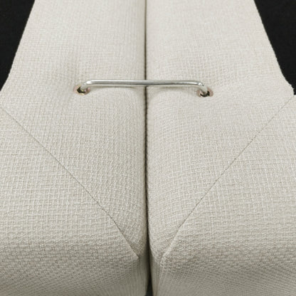 Close-up of beige upholstered cushions with a metal connector