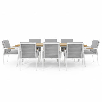 Casara 9 Piece Outdoor Dining Set in White and Grey: Light-wood table with slatted top, eight armchairs featuring white metal frames, gray woven sides, and cushioned seats, designed for alfresco dining.