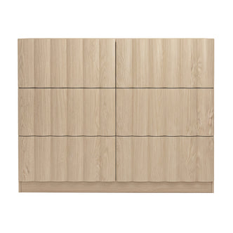 Front view of a light wood six-drawer dresser on white background