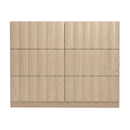Front view of a light wood six-drawer dresser on white background