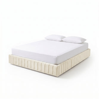 Modern upholstered cream-colored bed with white mattress and pillows on white background