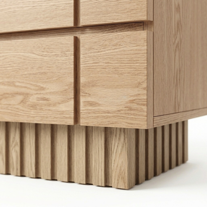 Close-up of the lower corner and fluted base of a wooden cabinet