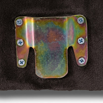 Close-up of metal bracket detail on dark surface