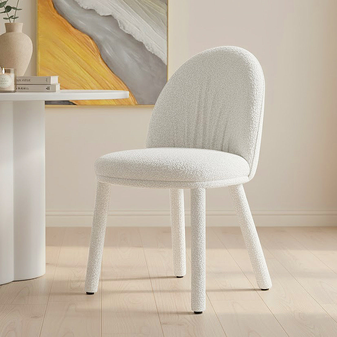 Joren Boucle Arched Dining Chair Set of 2 in Cream, featuring textured off-white bouclé fabric, curved low backrest, round padded seat, and straight fabric-wrapped legs, against a light-filled, modern room setting.