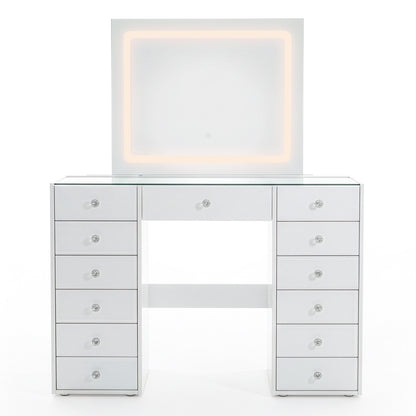White vanity table with lit mirror and crystal drawer knobs on white background