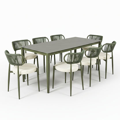 Cabria 9 Piece Sintered Stone Outdoor Dining Set in Green features a long rectangular table with slim metal legs and eight matching chairs with slender frames, woven backrests, and light cushion seats.