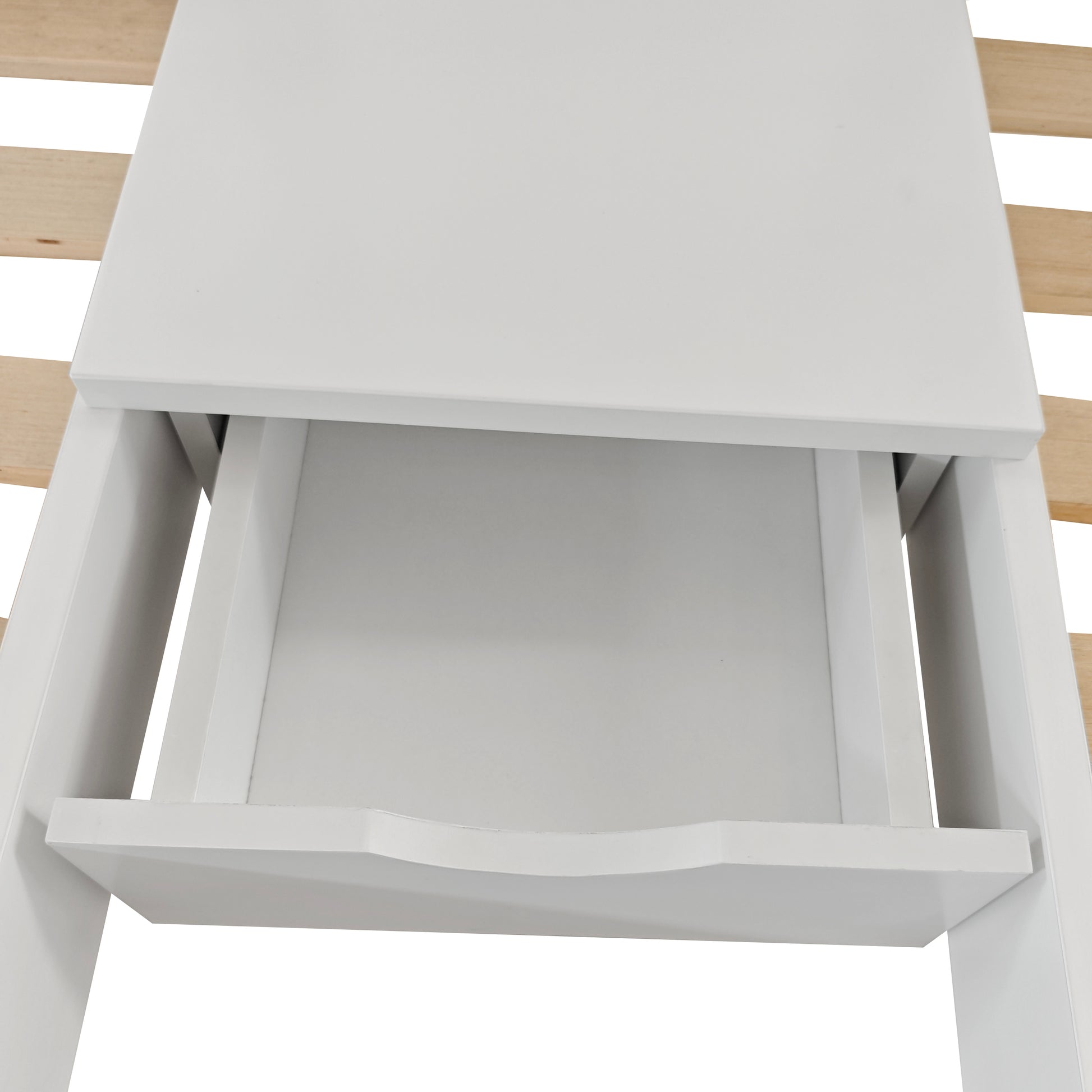 Aristos Triple Bunk Bed with Side Table in White features a partially open white storage drawer with a curved handle, suggesting integration into a larger furniture piece.