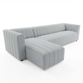 Parisa 4 Seater Tufted Boucle Sofa with Chaise in Light Grey, featuring a modern L-shape, low profile, squared arms, vertical channel tufting, and plush bouclé upholstery for a cozy, inviting look.
