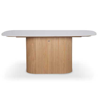 Aeris 180cm Marble Look Dining Table With Wood Base in Oak features a rounded rectangular white tabletop and a sturdy, fluted light-wood pedestal base, ideal for modern dining or conference settings.