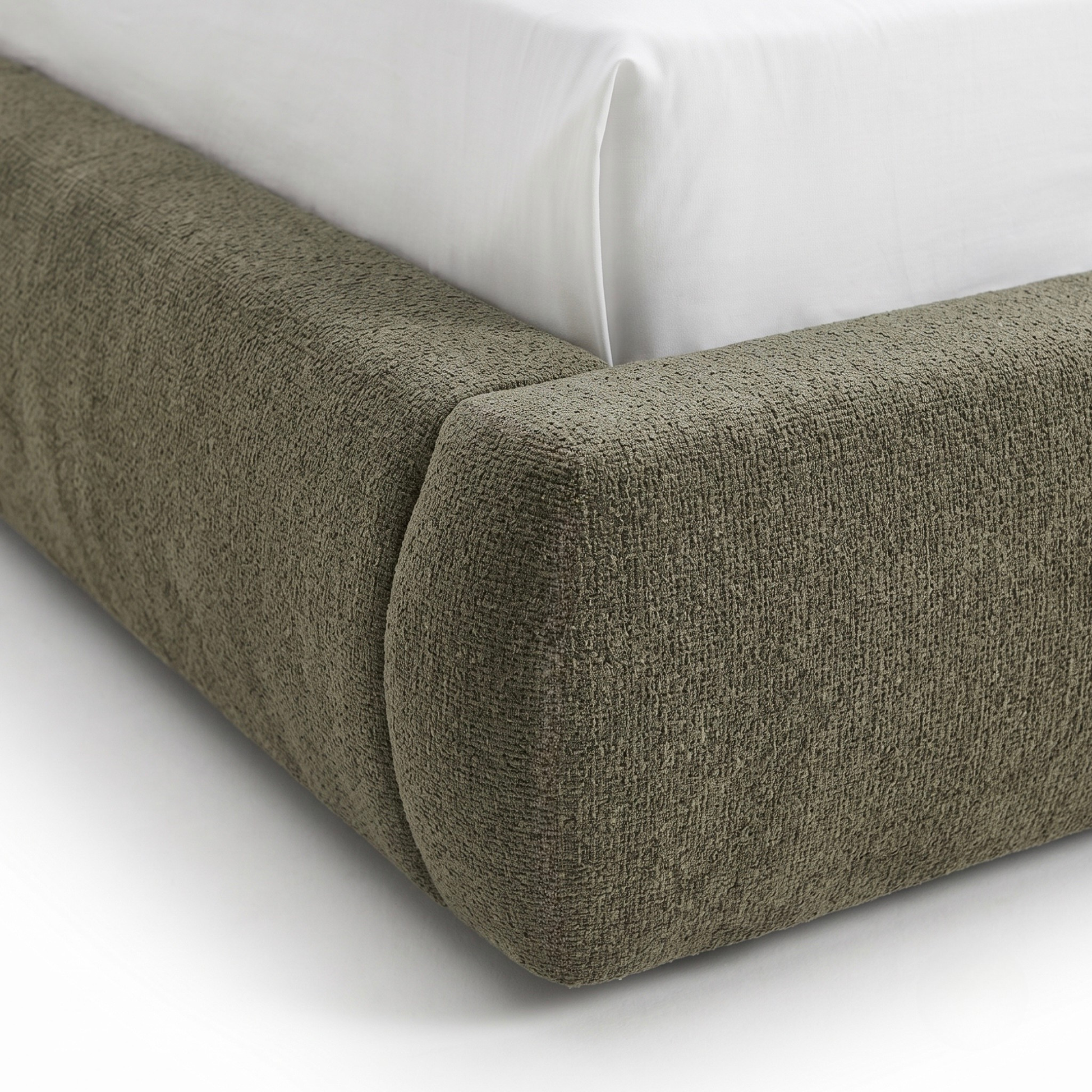 Close-up of upholstered bed frame corner on white background