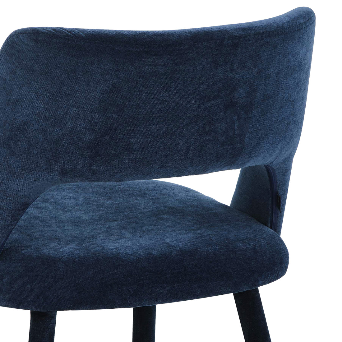 Close-up of dark blue chair curved backrest and velvet upholstery texture on white background