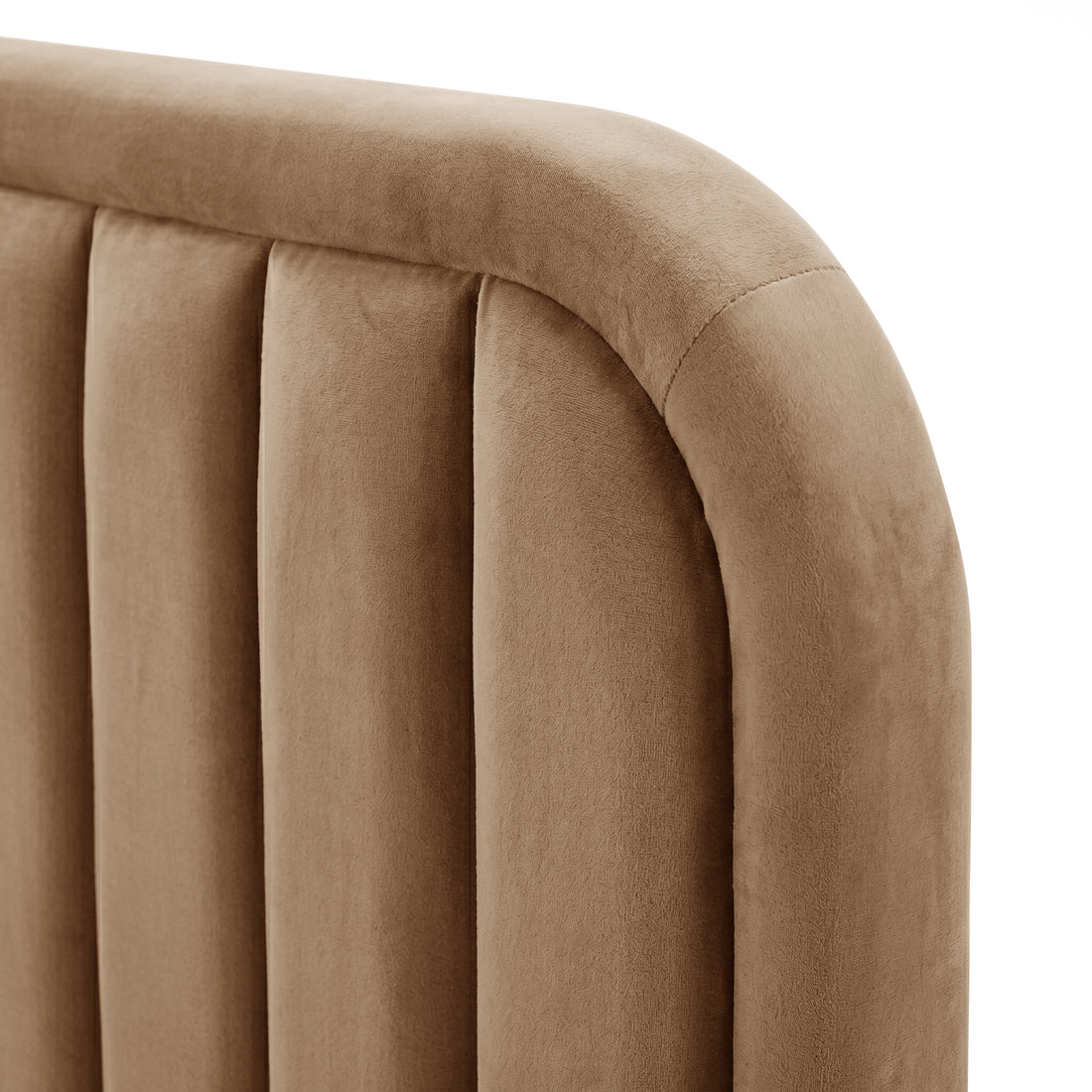 Detail close-up of tan velvet upholstery and channel tufting on a white background