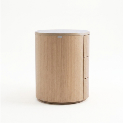 Circular wooden nightstand with three drawers on a white background