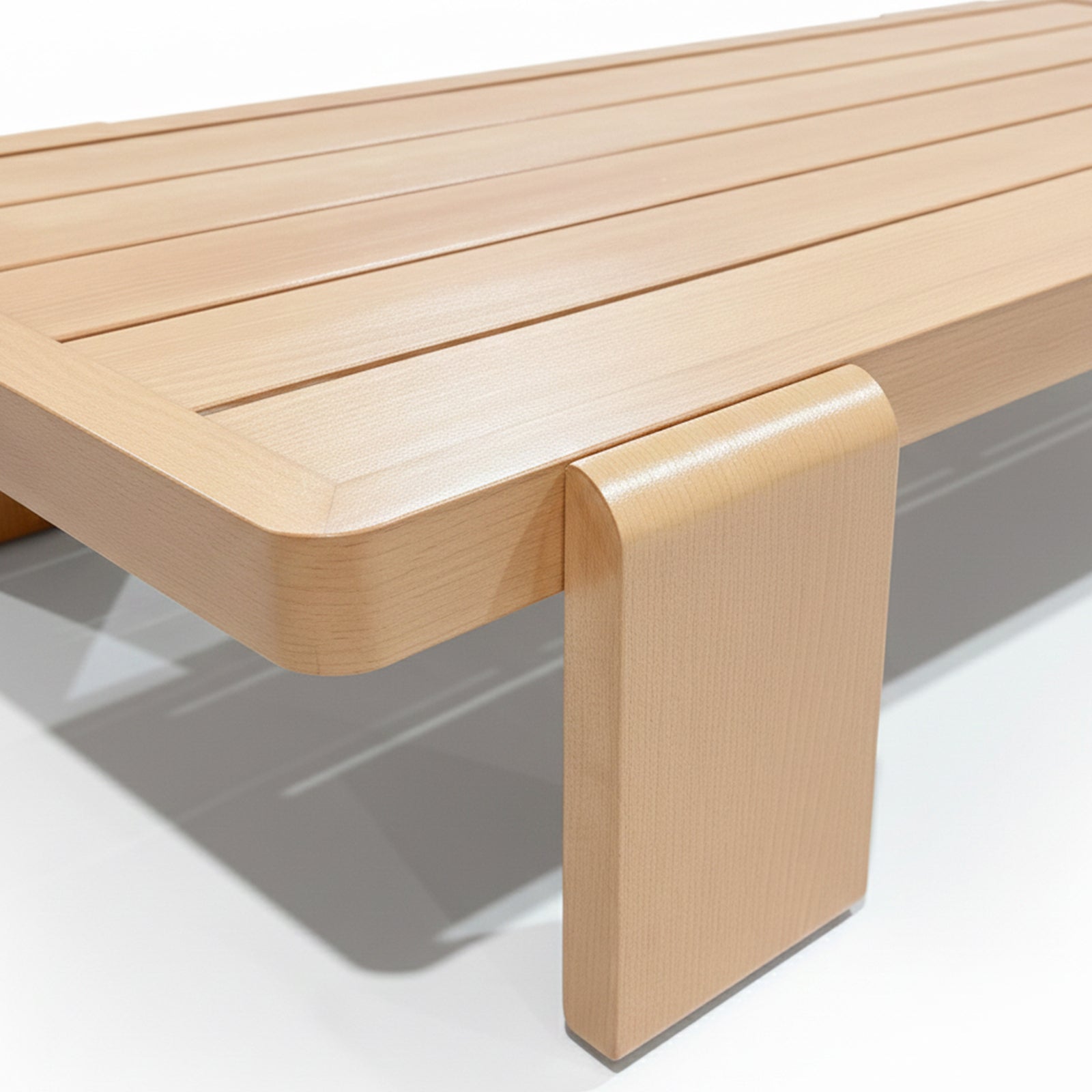 Close-up of the Modica 5 Seater Aluminium Outdoor Sofa Set in White, showcasing a minimalist slatted tabletop with softly rounded edges and a bent-plywood style leg, embodying modern elegance.