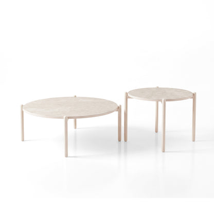 Two round coffee tables with light wood tops and three legs on a white background