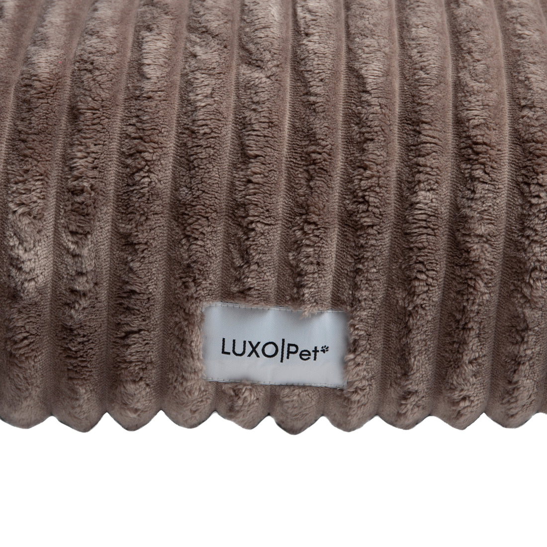 Close-up of plush ribbed brown fabric surface on white background