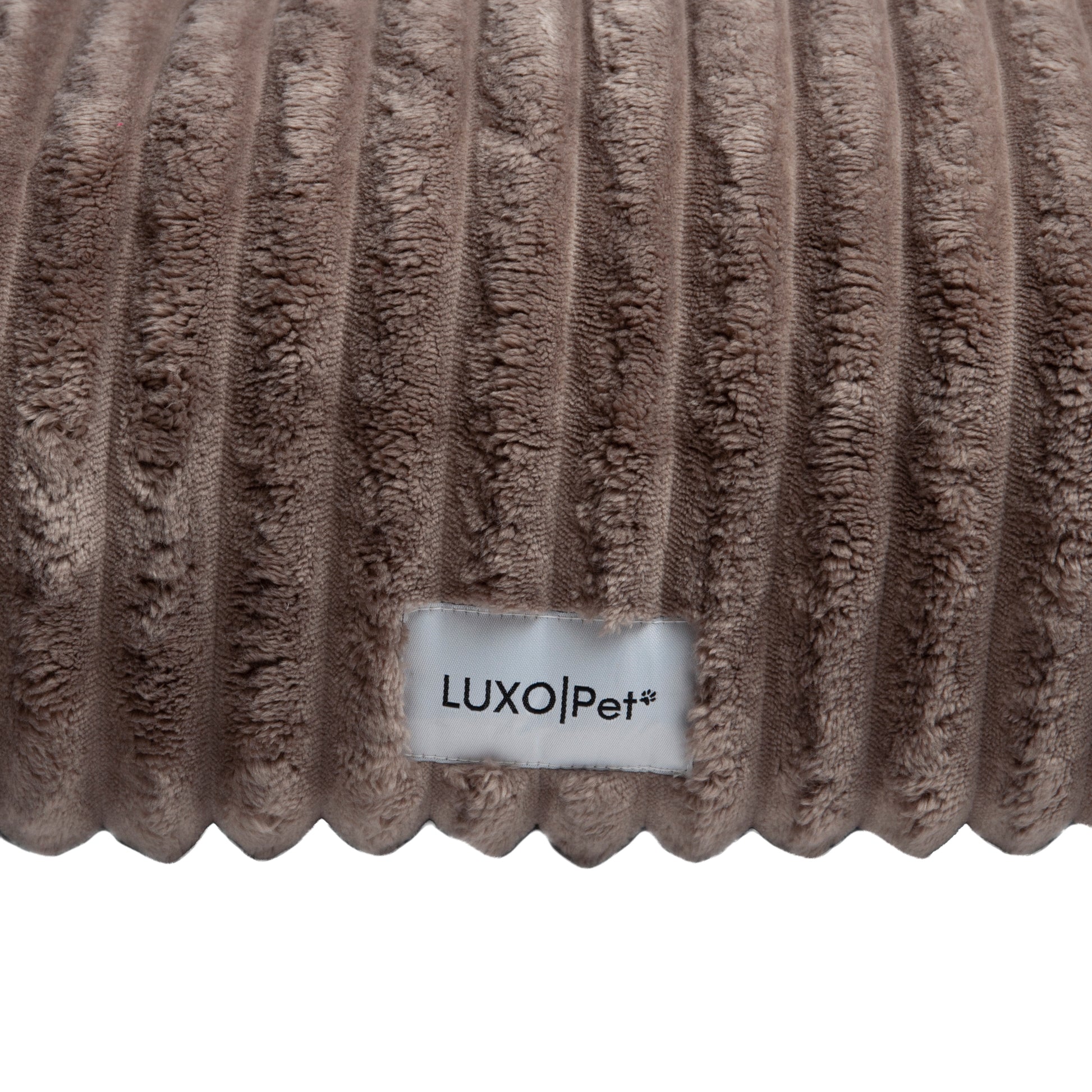 Close-up of plush ribbed brown fabric surface on white background