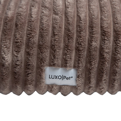 Close-up of plush ribbed brown fabric surface on white background